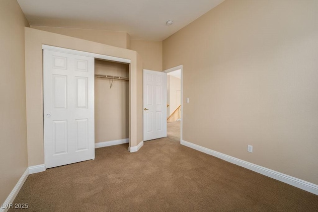 unfurnished bedroom featuring carpet and a closet