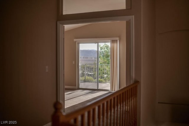 doorway to outside featuring lofted ceiling