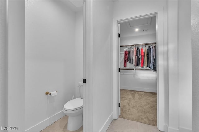 bathroom featuring tile patterned flooring and toilet