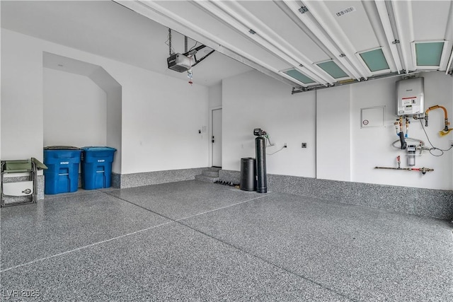 garage with a garage door opener and water heater