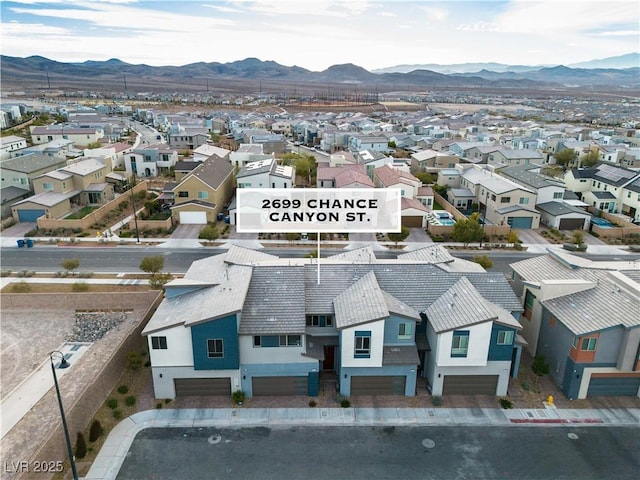 birds eye view of property with a mountain view