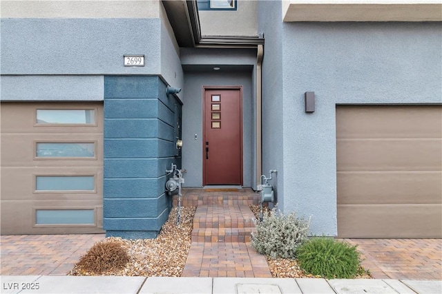 doorway to property with a garage