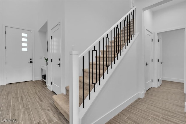 foyer with light hardwood / wood-style flooring and a high ceiling