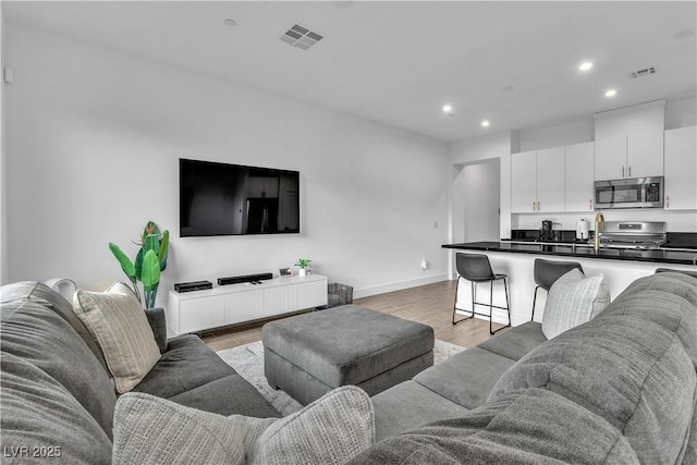 living room with light hardwood / wood-style floors