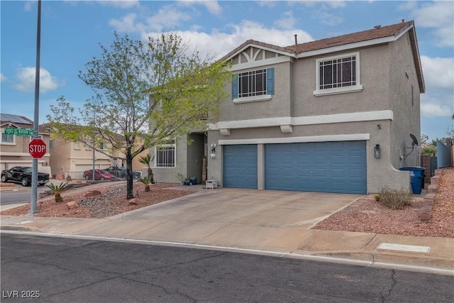 view of front facade featuring a garage, concrete driveway, and stucco siding