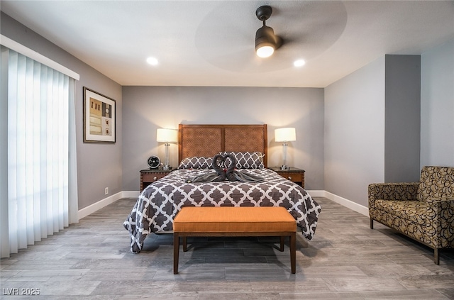 bedroom featuring multiple windows, ceiling fan, and light wood-type flooring