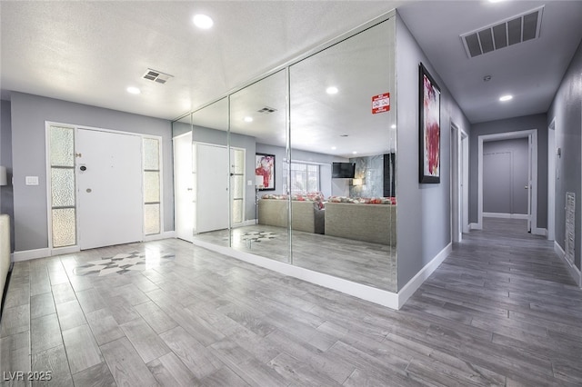 interior space with wood-type flooring and a textured ceiling