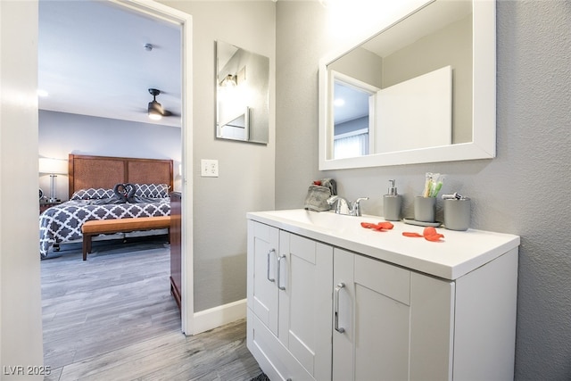 bathroom with vanity, hardwood / wood-style floors, and ceiling fan