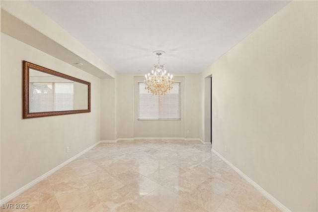 empty room featuring a chandelier