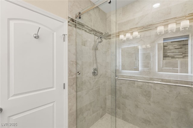 bathroom with a shower with shower door