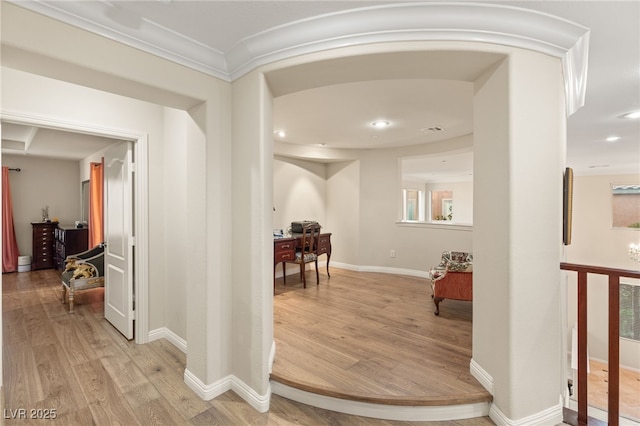 hall featuring ornamental molding and light hardwood / wood-style flooring