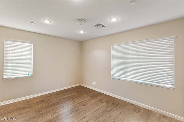 unfurnished room with wood-type flooring