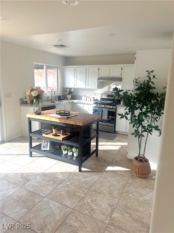 kitchen featuring white cabinetry, sink, and stainless steel gas range