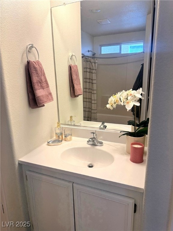 bathroom with vanity and a shower with shower curtain