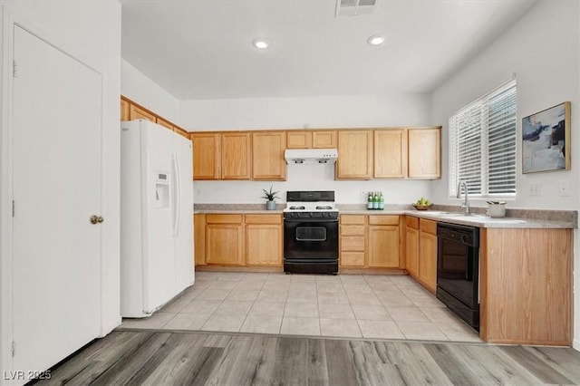 kitchen featuring sink, dishwasher, white refrigerator with ice dispenser, light brown cabinetry, and gas range