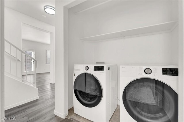 laundry area featuring hardwood / wood-style flooring and independent washer and dryer