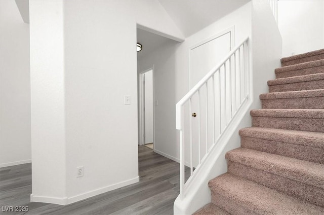 stairs featuring wood-type flooring