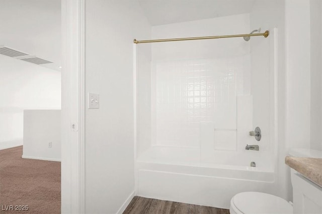 full bathroom featuring hardwood / wood-style flooring, vanity, bathtub / shower combination, and toilet