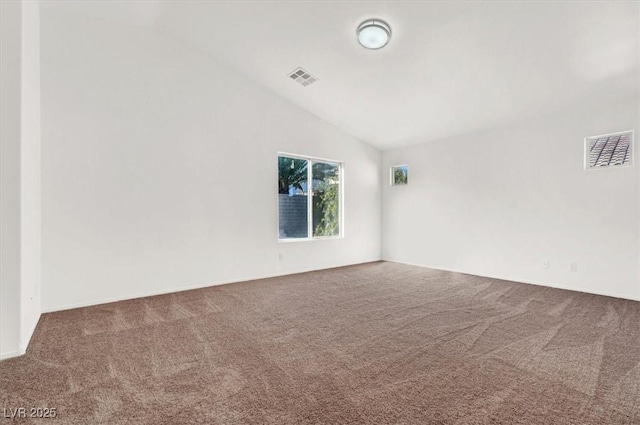 empty room with lofted ceiling and carpet