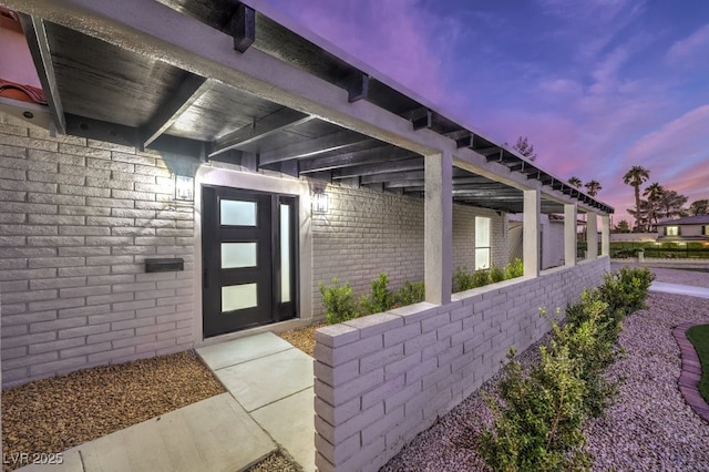 property entrance with brick siding