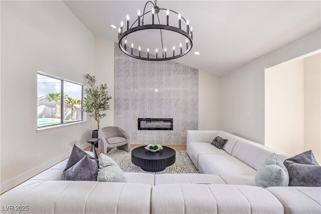 living area with lofted ceiling, a chandelier, recessed lighting, baseboards, and a tiled fireplace