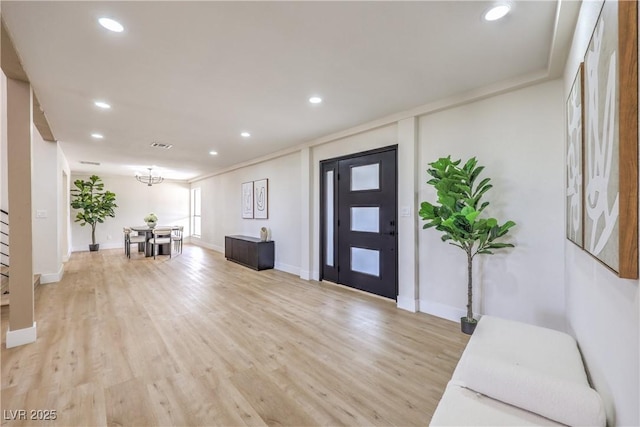 entrance foyer featuring light wood-style floors, baseboards, and recessed lighting