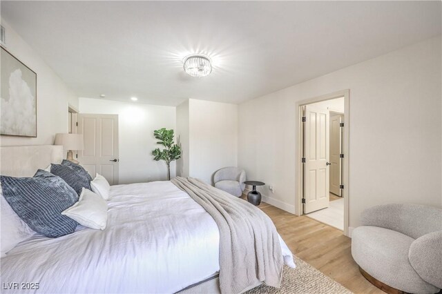 bedroom with baseboards and light wood-style floors