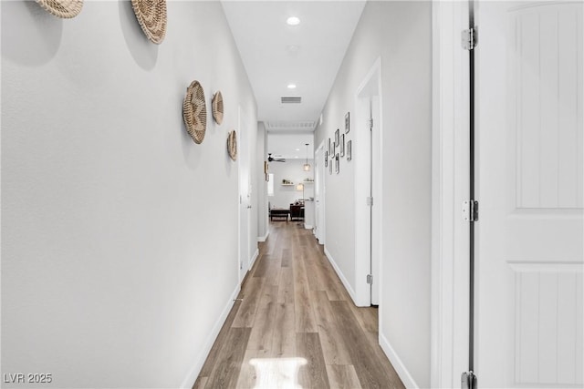 hall with light hardwood / wood-style flooring