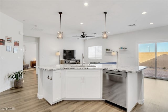 kitchen with pendant lighting, sink, dishwasher, and white cabinets