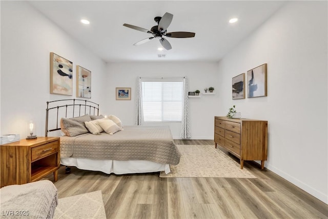 bedroom with ceiling fan and light wood-type flooring