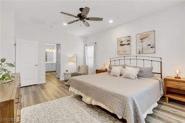 bedroom featuring ensuite bathroom, ceiling fan, and light hardwood / wood-style flooring