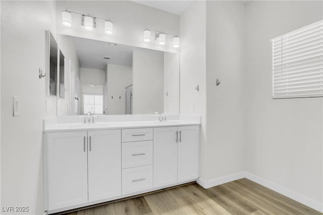 bathroom featuring hardwood / wood-style flooring and vanity