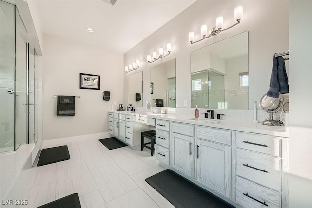 bathroom with vanity and a shower with door