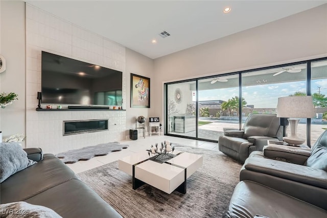 living room featuring tile patterned floors and a tile fireplace