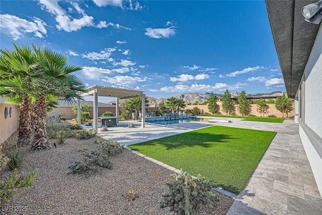 view of yard featuring a fenced in pool, a pergola, a mountain view, and a patio area