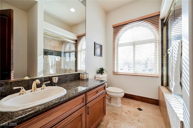 bathroom featuring vanity, a healthy amount of sunlight, an enclosed shower, and toilet