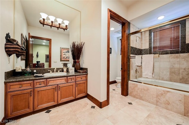 full bathroom featuring vanity, shower / bath combination with glass door, and toilet