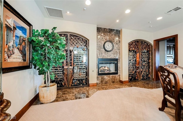 wine area featuring carpet floors and a fireplace