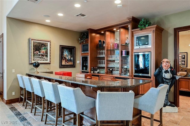 bar with dark stone countertops