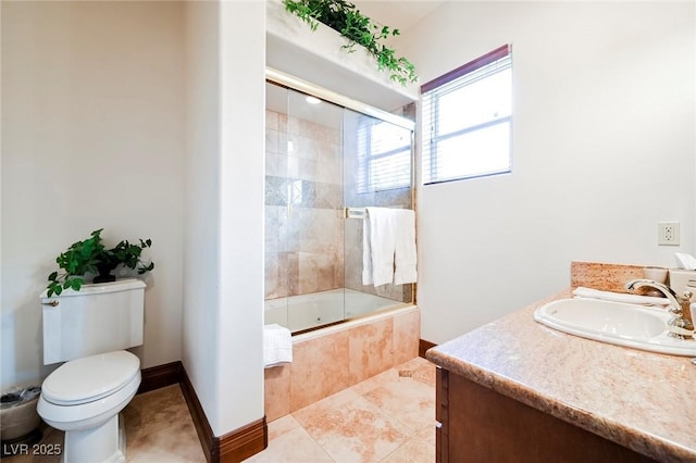 full bathroom with vanity, combined bath / shower with glass door, tile patterned floors, and toilet