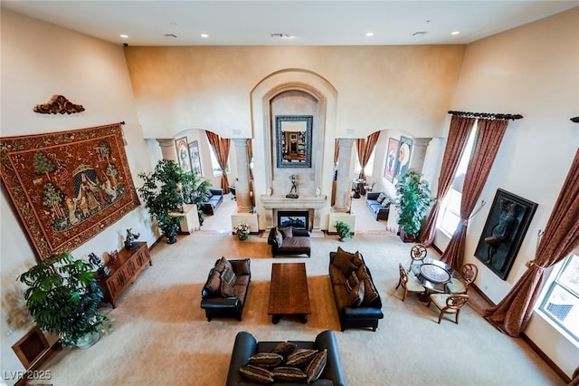 carpeted living room featuring decorative columns