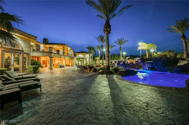 view of pool with pool water feature and a patio area