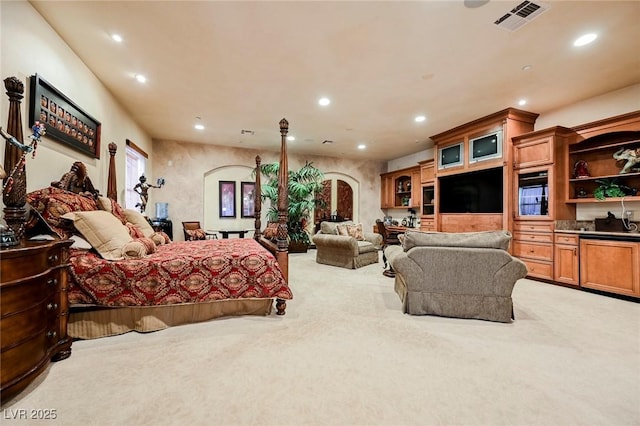 bedroom featuring light carpet