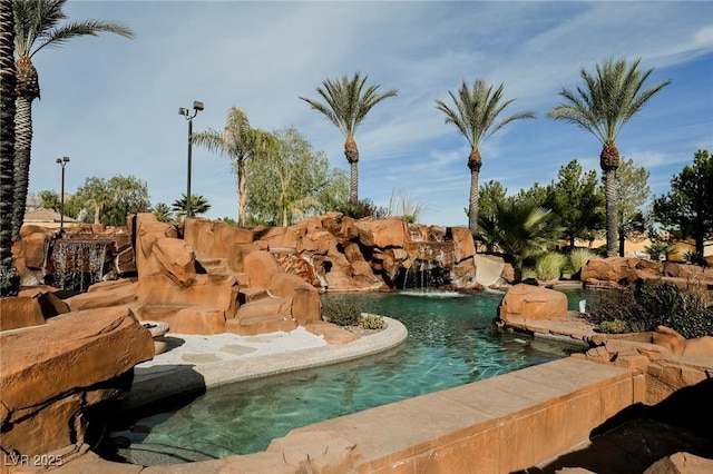 view of pool with pool water feature