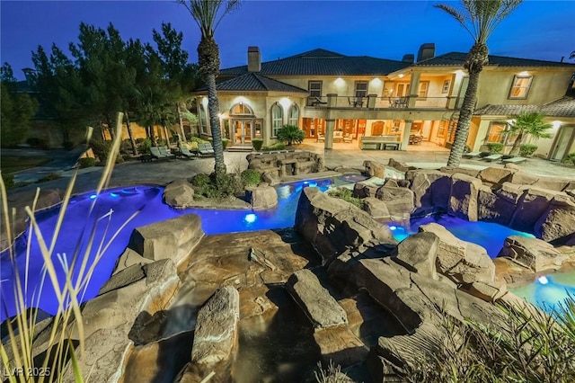 view of pool with a jacuzzi, a patio, and french doors