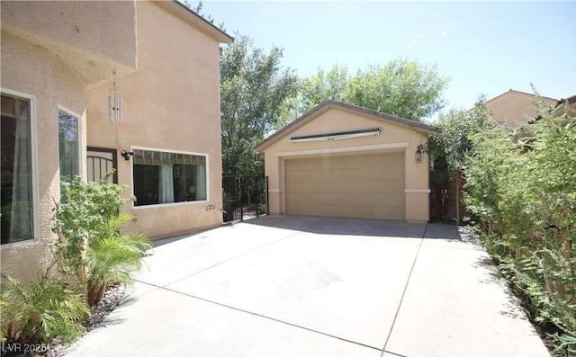 view of side of property with a garage and an outdoor structure