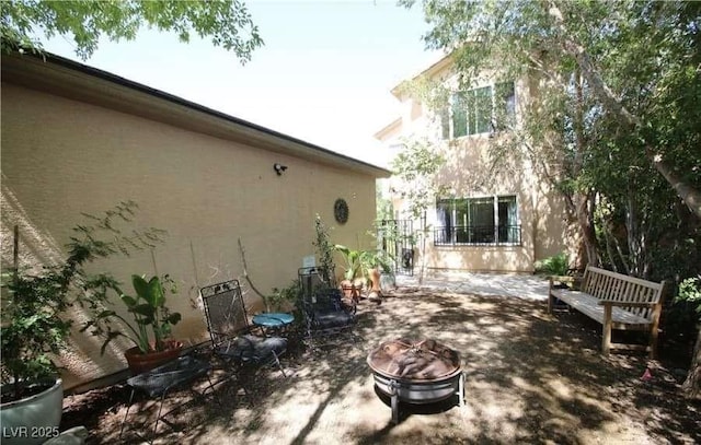 exterior space featuring a fire pit and a patio