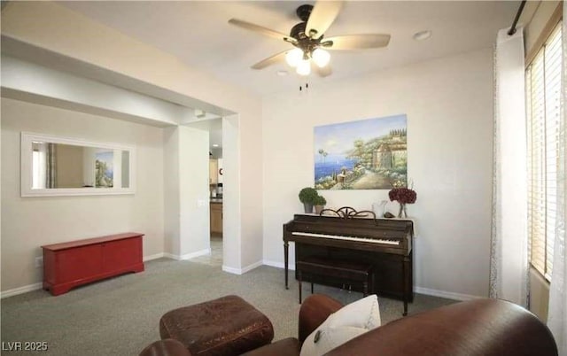 interior space featuring ceiling fan and carpet