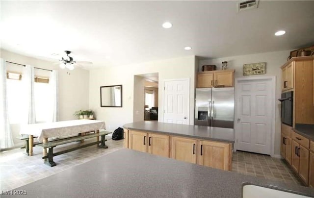 kitchen featuring a kitchen island, light brown cabinetry, oven, ceiling fan, and stainless steel fridge with ice dispenser