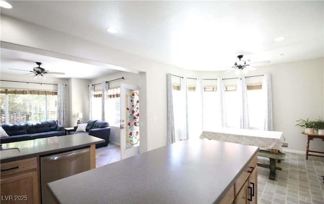 kitchen featuring ceiling fan, a center island, and dishwasher